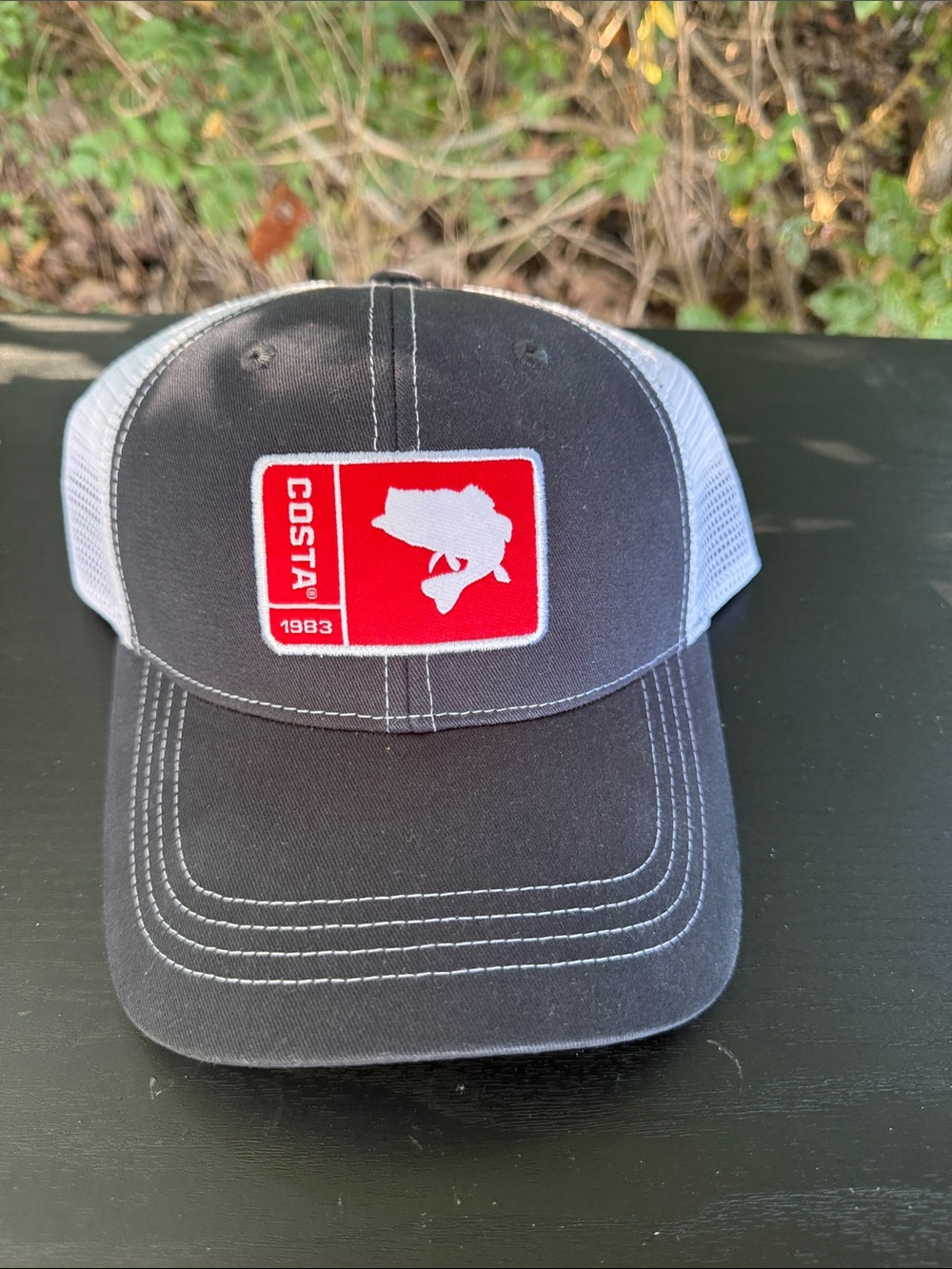 Costa Charcoal Front Trucker Hat with White Mesh and Red Patch